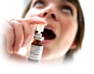Patient spraying medicine in her mouth