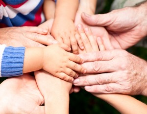 Family holding hands together closeup