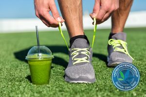 Green smoothie fitness man lacing running shoes, Athlete runner